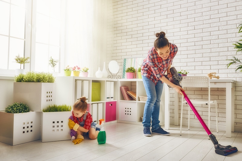 Do air conditioners eliminate mold? - Happy family cleans the room. Mother and daughter do the cleaning in the house. A young woman and a little child girl wiped the dust and vacuumed the floor.