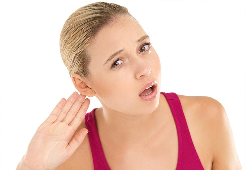 A woman having difficulty in hearing.