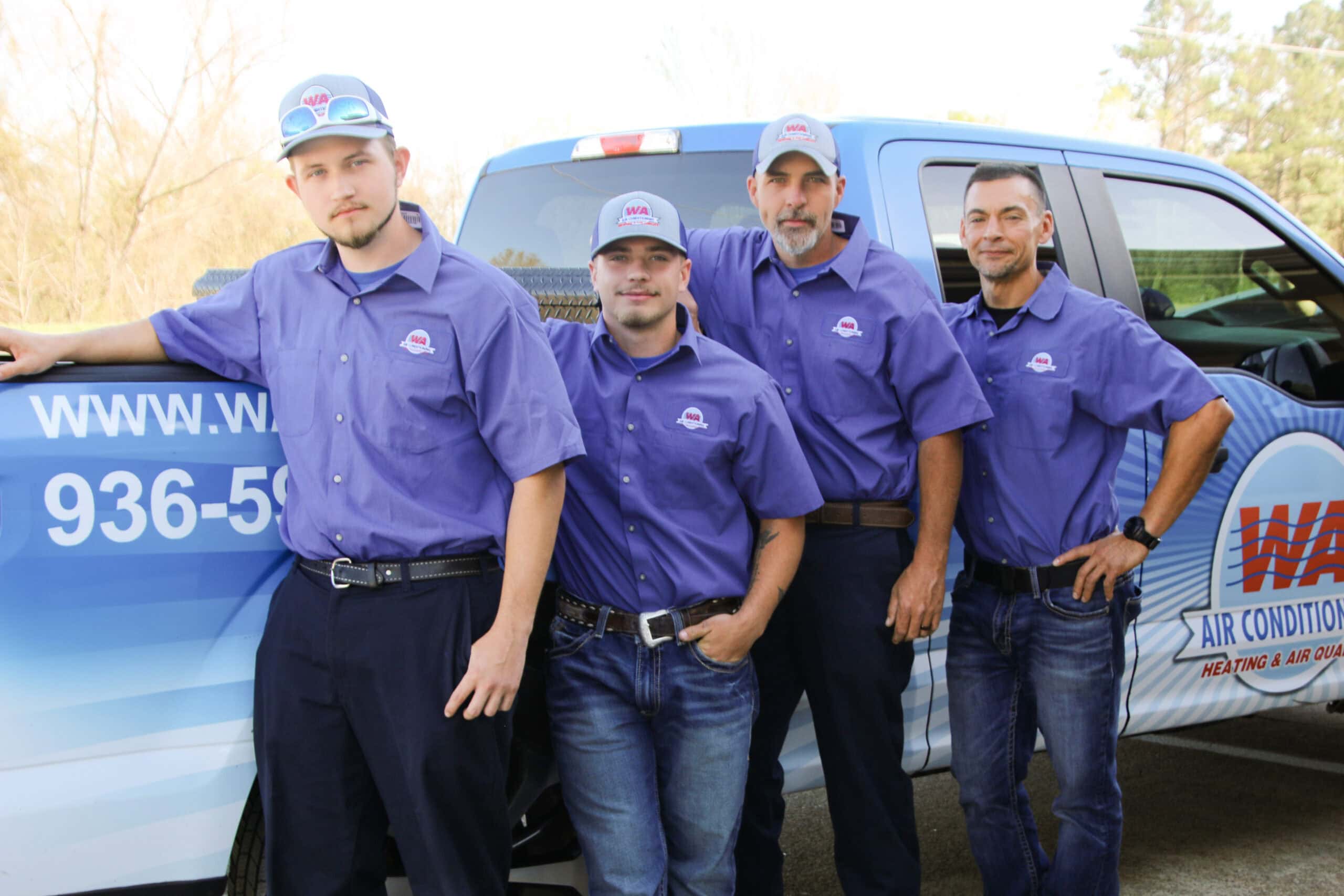 W A Air Conditioning service team posing in front of company service truck.