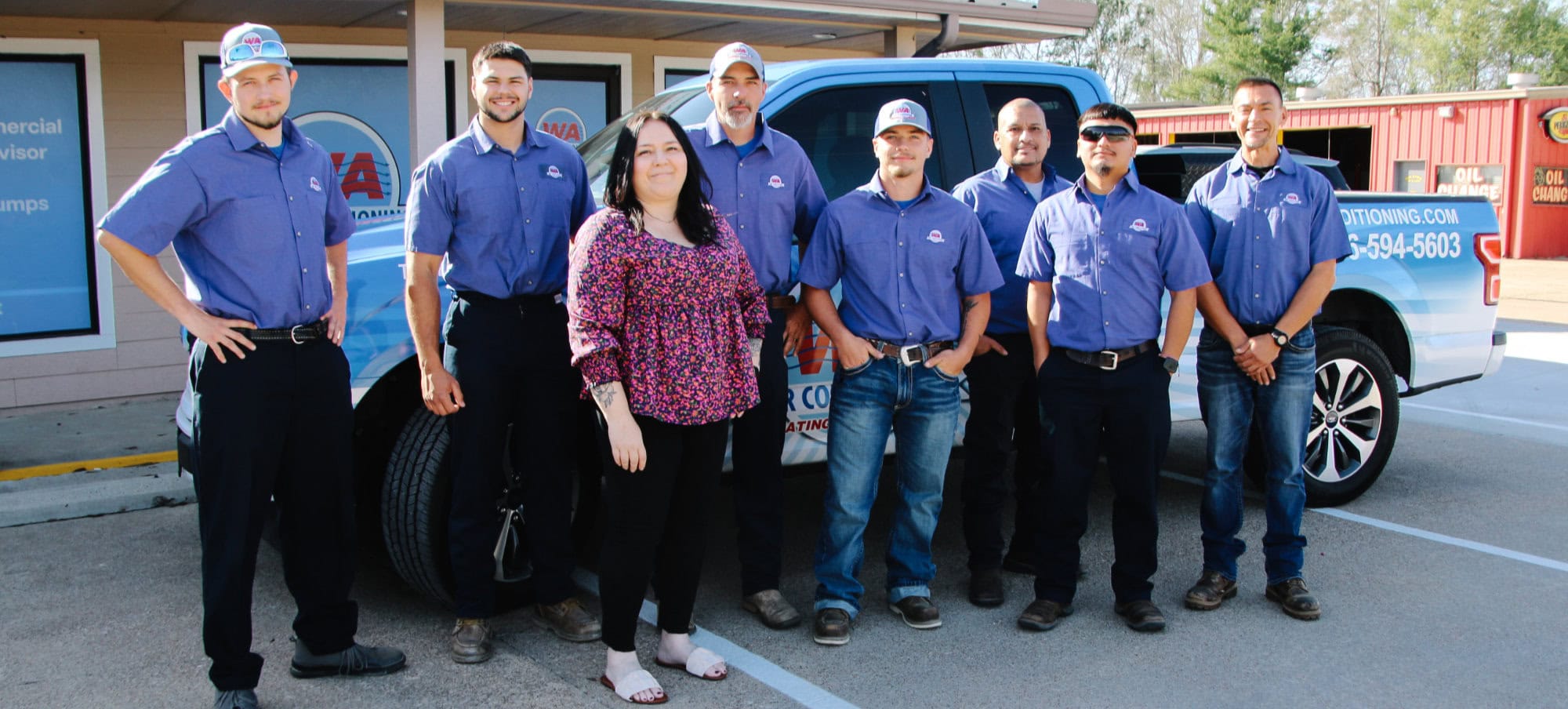 W A Air Conditioning team standing in front of company vehicle at Trinity, TX, office.